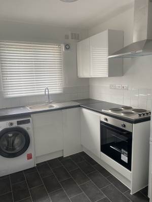 Completed family bathroom with bath, screen and tiling in Rochester