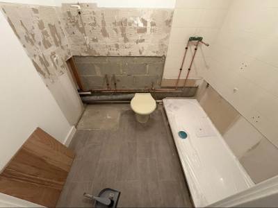 Waste pipework connected under a newly fitted bathroom suite